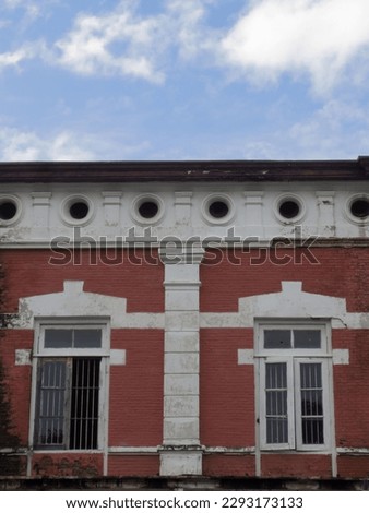 Windows of the red vintage building with blue sky on the above. Historical building in Kota Lama, Semarang. 