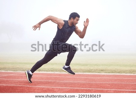 Gaining some serious speed. Full length shot of a handsome young male athlete running on an outdoor track. Royalty-Free Stock Photo #2293180619