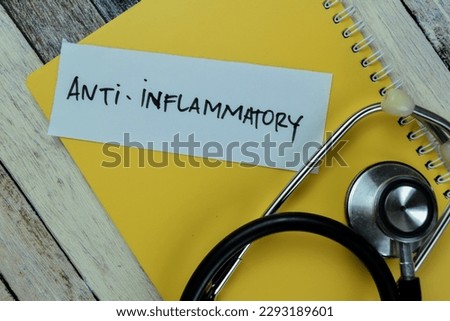 Concept of Anti - Inflammatory write on sticky notes with stethoscope isolated on Wooden Table. Royalty-Free Stock Photo #2293189601