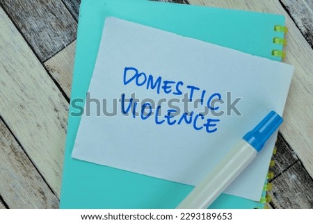 Concept of Domestic Violence write on sticky notes isolated on Wooden Table. Royalty-Free Stock Photo #2293189653