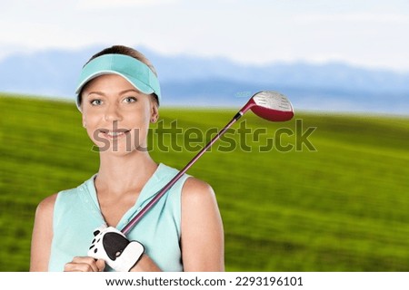 Young woman golfing on the green course in summer