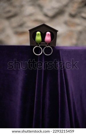 birds keychain on purple background