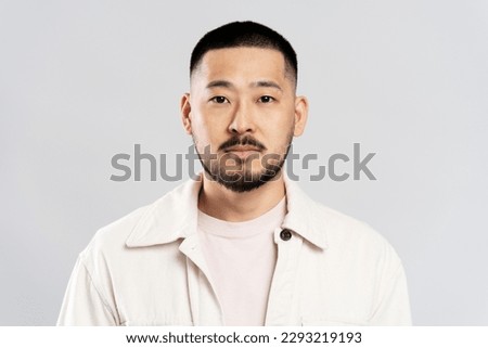 Portrait of handsome serious asian man with stylish hair, wearing casual clothes, looking at camera after barbershop service, isolated on white background Royalty-Free Stock Photo #2293219193