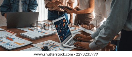 Panorama shot analyst team utilizing BI Fintech to analyze financial report with laptop. Businesspeople analyzing BI power dashboard displayed on laptop screen for business insight. Scrutinize Royalty-Free Stock Photo #2293235999