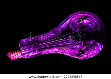 A colorfully illuminated light bulb