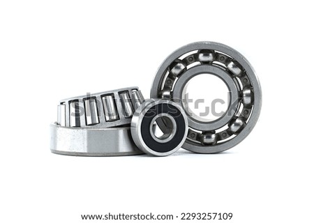 Ball bearings and tapered roller bearing isolated on white background. Car bearings, auto parts, automobile components for the engine and chassis suspension Royalty-Free Stock Photo #2293257109