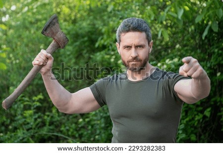 man threatening with hatchet wearing shirt, selective focus. man threatening with hatchet Royalty-Free Stock Photo #2293282383