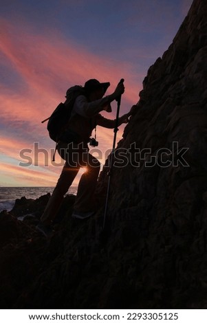 Male hiker climbing up mountain cliff , adventure travel on cliff mountain, backpacker adventure travel lifestyle