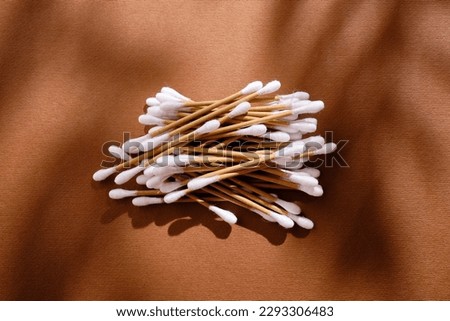 Bamboo cotton buds on a colored background. Biodegradable ear swabs. Eco product