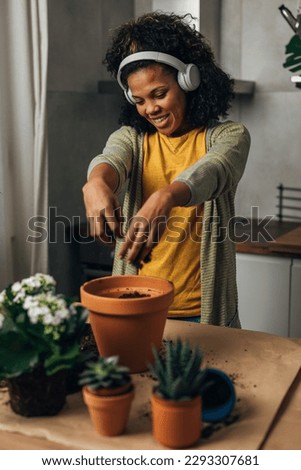 Happy woman enjoys working with plants.