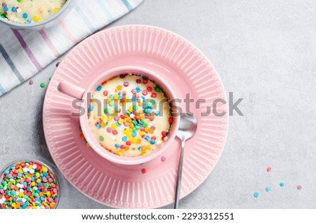 Funfetti Mug Cake, Homemade Cake Cooked in the Microwave on Bright Background Royalty-Free Stock Photo #2293312551