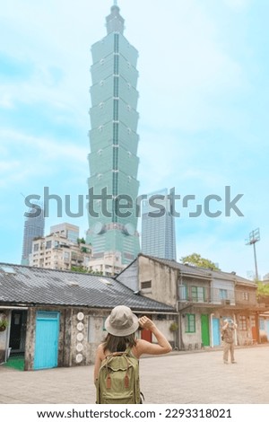 woman traveler visiting in Taiwan, happy Tourist sightseeing in Si Si Nan Cun or Old Military Village against Taipei city, landmark and popular attractions. Asia Travel,  vacation and Trip concept Royalty-Free Stock Photo #2293318021