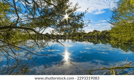 Sun_star,lake,tree,reflection,beaut,nature.This picture is looking awesome act as nature and beauty.