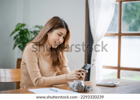 Asian woman texting checking social media holding smartphone at home Conversation with boyfriend or friend
