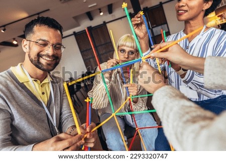 Team building activities in the office with sticks.Concept of friendship, teambuilding and teamwork.  Royalty-Free Stock Photo #2293320747
