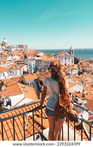 Traveler Woman, tourist on balcony looking at panoramic view of Lisboa- Tourism, vacation, travel in Portugal Royalty-Free Stock Photo #2293324399