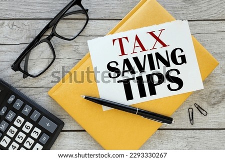 Tax Savings . torn page from a notebook on a yellow notepad. view from above Royalty-Free Stock Photo #2293330267