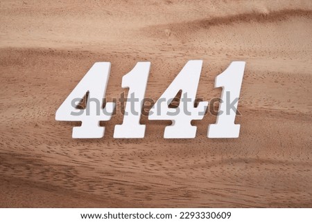 White number 4141 on a brown and light brown wooden background.