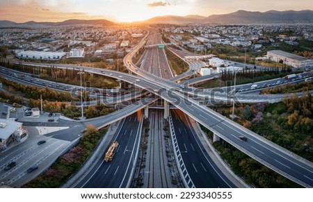 Aerial panoramic view of multilevel junction highway road as seen in Attiki Odos toll road motorway, Athens, Greece, during golden sunset time Royalty-Free Stock Photo #2293340555