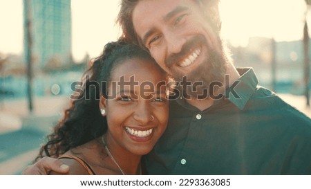 Close-up portrait of happy interracial couple in the port, backlighting Closeup, young woman and man hugging and smiling looking at the camera Royalty-Free Stock Photo #2293363085