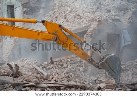 Demolition of building. Excavator breaks old house. Freeing up space for construction of new building Royalty-Free Stock Photo #2293374303