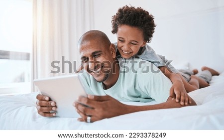 Happy father, child and watching on tablet in bed for fun streaming or entertainment together at home. Dad, son or kid with smile relaxing with technology for movie, series or education in bedroom