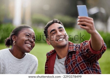 Me and my girl got a good thing going. a young man and woman taking selfies on a study break at college.