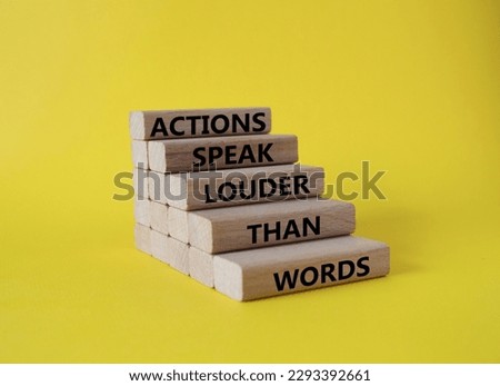 Actions speak louder than Words symbol. Wooden blocks with words Actions speak louder than Words. Beautiful yellow background. Business and Actions concept. Copy space.