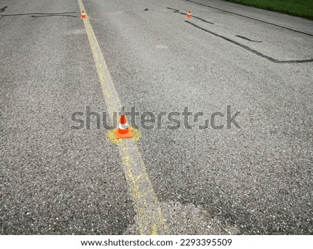 Small orange cones on the road as a marker.