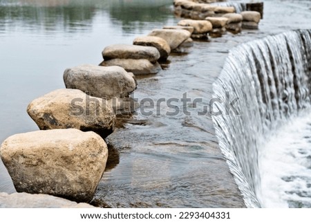 Stone path over a river. Royalty-Free Stock Photo #2293404331