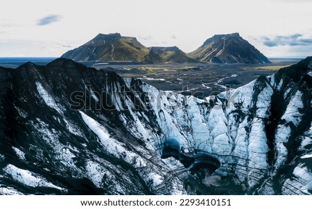 Aerial view Glacier landscape. Blue ice on the mountain. Climate Change and Global Warming. Ice Cave near Vik, Iceland, Katla. Beautiful aerial photo of ice water and glacier. Panoramic shot.