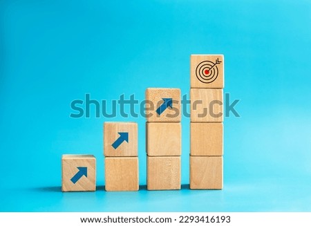 Goal and success. Arrow dart, target icon on top of wooden cube blocks, bar graph steps with up arrows. Business growth process, development, leadership, marketing, economic improvement concepts.
