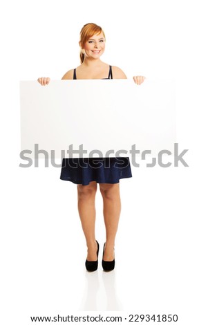 Beautiful large woman holding a white board