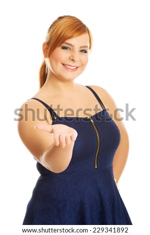 Happy overweight woman presenting something
