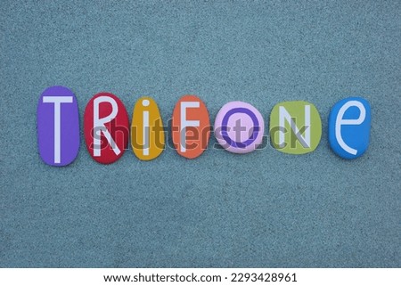 Trifone, italian boy name, greek origin, composed with multi colored stone letters over greeen sand