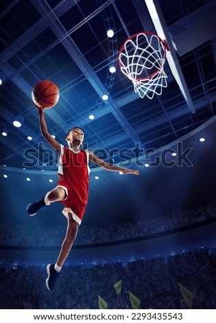 Dynamic image of little boy, child, basketball player in motion, jumping with ball during match on 3D stadium with flashlights. Championship. Concept of professional sport, competition, action, motion