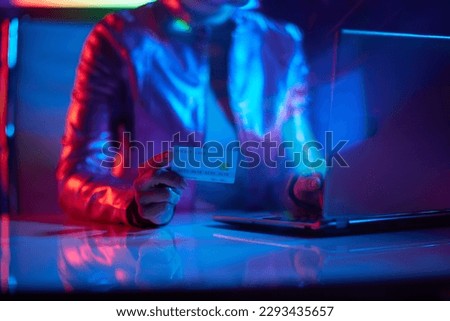 Neon metaverse futuristic concept. Closeup on woman with laptop and credit card in office.