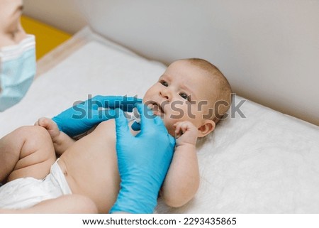 Pediatrician is administring oral vaccination against rotavirus infection to little baby. Children health care and disease prevention.  Royalty-Free Stock Photo #2293435865