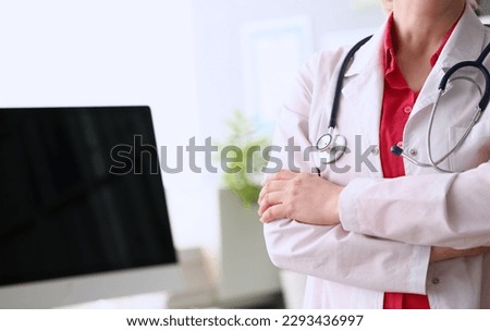 Female doctor standing with arms crossed on chest