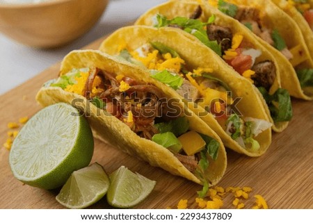 Mexican hard-shell taco with chicken and beef and shrimp 