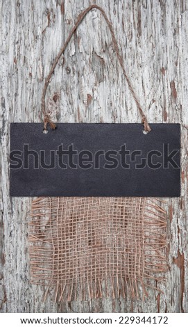 Chalkboard with rope on the old wood background
