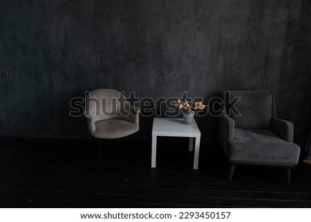 an armchair coffee table flowers in the room interior