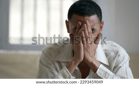 One troubled young man struggling with mental health issues at home, feeling overwhelmed and helpless Royalty-Free Stock Photo #2293459049