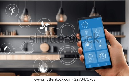 Smart home technology interface on smartphone app. Screen with augmented reality view of internet of things connected objects in the apartment interior. Person is holding device.