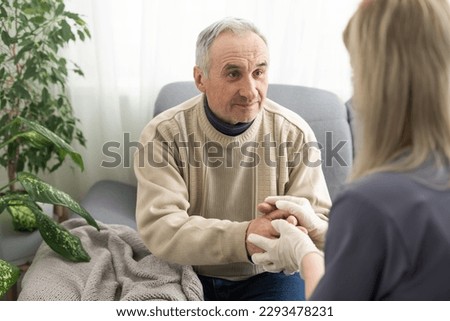 Kind female doctor embracing encouraging senior male patient in hospital. Happy healthy older man and his physician enjoying talking at nursing home. Elderly medical health care concept. Royalty-Free Stock Photo #2293478231