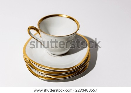 Golden fragile porcelain coffee cups