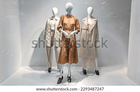Female mannequins in shop window. Three women dummies show fashionable clothes Royalty-Free Stock Photo #2293487247