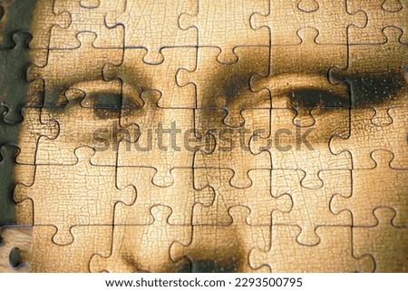 Jigsaw Puzzle Of Female Face Mona Liza La Gioconda from Leonardo Da Vinci, from ancient painting on wooden background, closeup Royalty-Free Stock Photo #2293500795