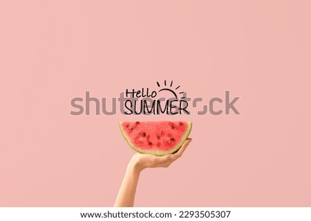 Hand with piece of ripe watermelon and text HELLO, SUMMER on pink background