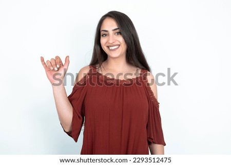 young brunette woman wearing red shirt over white studio background showing up number six Liu with fingers gesture in sign Chinese language